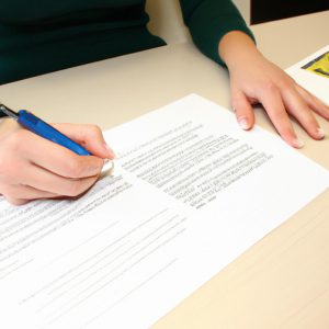 Person signing loan consolidation paperwork