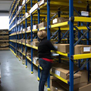 Person organizing shelves in warehouse